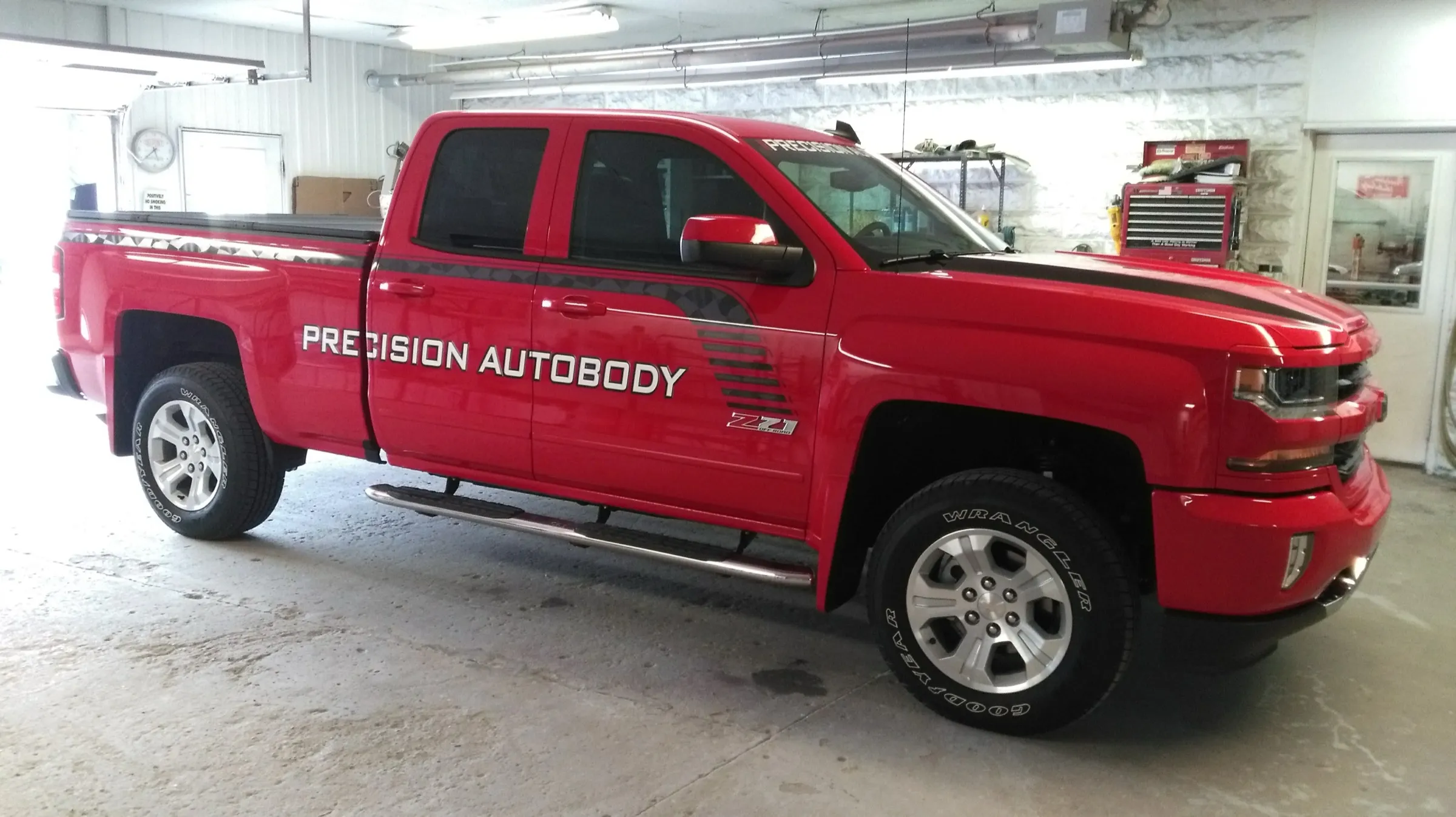 Red Chevrolet Silverado inside the shop during a tint installation